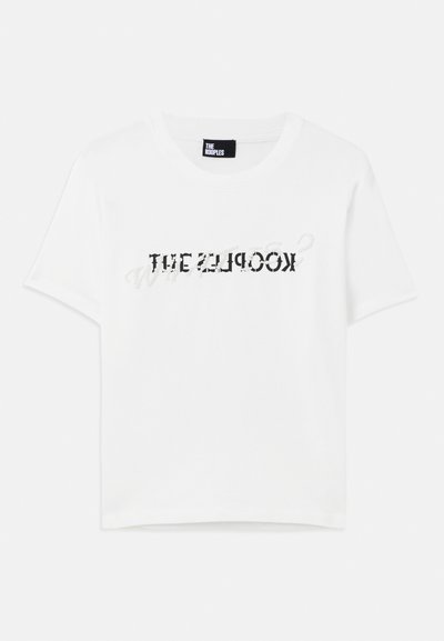 White cotton t-shirt with short sleeves and a round neckline, featuring a black graphic text design that reads "THE KOOPLES."