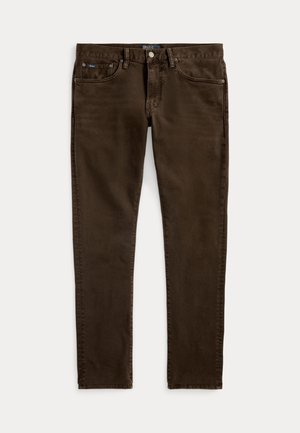 Brown cotton jeans with a slim fit, featuring five pockets, a metal button closure, and subtle fading on the fabric.