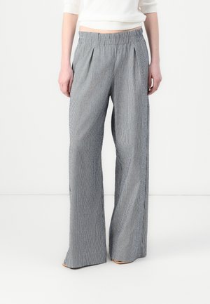 Wide-leg trousers with a vertical striped pattern in blue and white. Features an elastic waistband and front pleats. Lightweight fabric texture.
