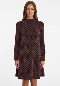 Long-sleeve, knee-length dress in dark burgundy with a textured diamond pattern. Features a high neckline and a flared skirt.