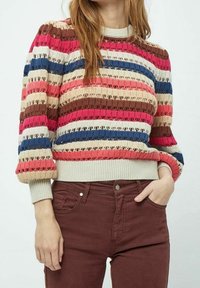 Knit sweater with multicolored horizontal stripes in red, pink, brown, and blue. Features textured fabric and ribbed cuffs and hem.