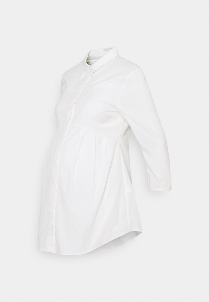 Vit gravidblus med knappstängning fram, krage och trekvartsärmar. Har rynkning vid midjan för komfort.