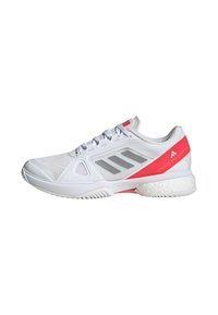 White athletic shoe with breathable mesh upper, gray stripes, and pink accents. Features cushioned sole and textured outsole for traction.