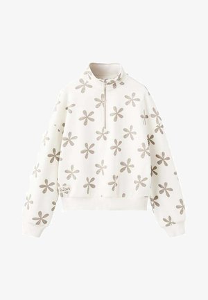 Hvid sweatshirt med lynlåshals, der har et gentaget sølvblomstermønster. Manchetter og kant er ribstrikkede, med en lille etiket i siden.