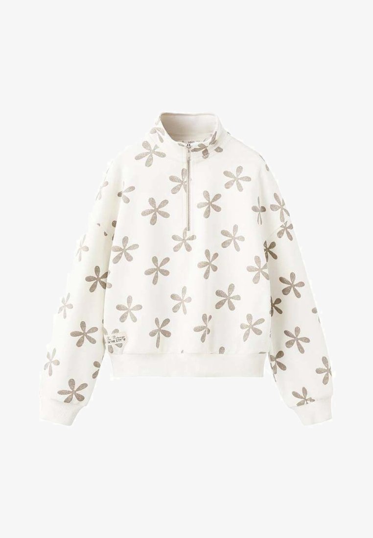 Felpa bianca con collo a zip, caratterizzata da un motivo floreale argentato ripetuto. Polsini e orlo sono a coste, con un piccolo etichetta sul lato.
