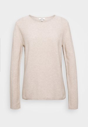 Lichtbeige longsleeve top gemaakt van zacht, textuurmateriaal. Ronde halslijn en rechte zoom, met minimale stiksels en zonder versieringen.