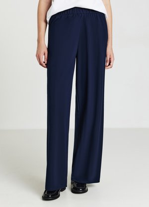 Marineblaue, leichte Stoffhosen mit einer lockeren Passform, elastischem Bund und weitem Bein, die eine glatte Textur und minimale Details aufweisen.