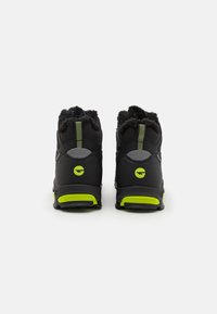 Black hiking boots with gray accents, fur-lined collar, lime green sole, and reflective rear strip. Features rugged textured upper for durability.