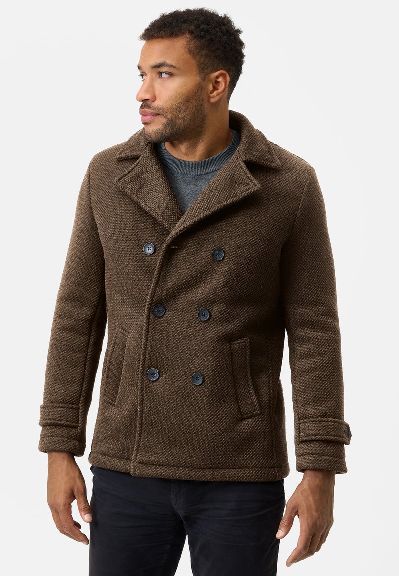 Brown woven peacoat with a double-breasted design, large black buttons, and side pockets. Features a notched collar and textured fabric.