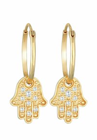 Boucles d'oreilles en or en forme de cercle, présentant un design de main de fatma, ornées de cristaux transparents, avec des textures détaillées et une finition métallique lisse.