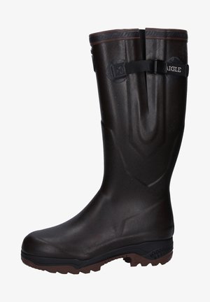 Brown rubber knee-high boots with textured surface, adjustable strap, and a sturdy sole. Slightly raised toe and contoured fit.