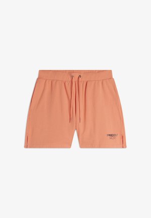 Pantalones cortos de color naranja claro hechos de una tela suave, con una cinturilla elástica, cordón, aberturas laterales y un pequeño logo metálico en el dobladillo izquierdo.