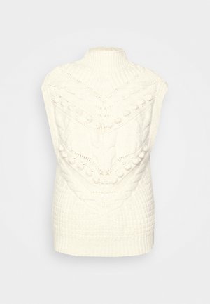Maglione lavorato a maglia color crema con un alto colletto a coste e motivi texture, inclusi trecce e pompon, che conferiscono un aspetto accogliente.