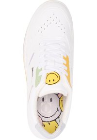 White sneaker featuring a smooth leather upper, colorful smiley face accents in green, yellow, and lavender, with perforated detailing and flat laces.