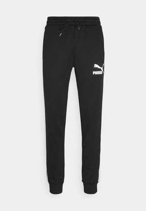 ICONIC - Tracksuit bottoms - black