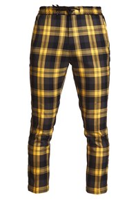 Pantalones de cuadros negros y amarillos con cintura elástica y cordón, con piernas rectas y acabado textil suave.