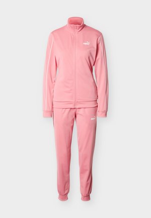 Ružová tepláková súprava z mäkkej látky, pozostávajúca z bundy so zipsom a vysokým golierom a zodpovedajúcich nohavíc s elastickými manžetami. S logom Puma.
