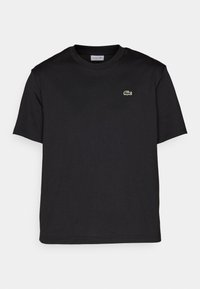 T-shirt noir à manches courtes et col rond avec un petit logo crocodile vert sur la poitrine gauche.