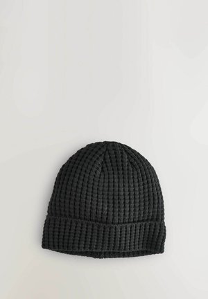 Schwarze Strickmütze mit geripptem Muster und umgeschlagenem Saum, ausgestattet mit einem engmaschigen Design. Keine sichtbaren Muster oder Verzierungen.