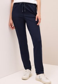 Mörkblå joggingbyxor i slätt tyg, med elastisk midja och dragsko, med en tapered passform och sidofickor.