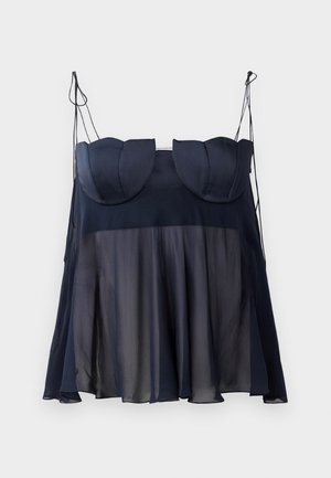 Navy blue sleeveless top with a layered design, featuring a soft, sheer lower half and structured upper with curved accents. Adjustable straps.