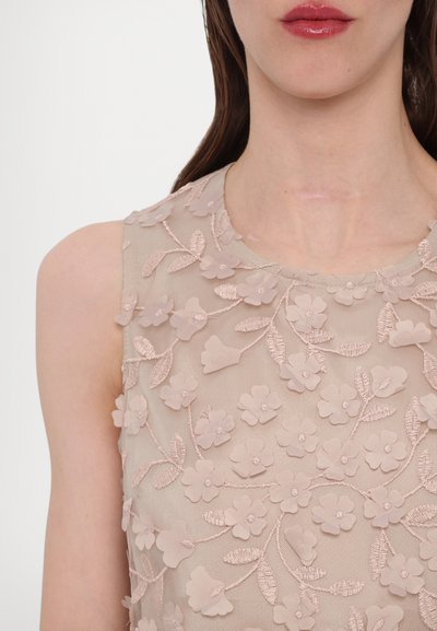 Beige sleeveless dress featuring floral embroidery, textured fabric, and a round neckline with intricate leaf and flower patterns.