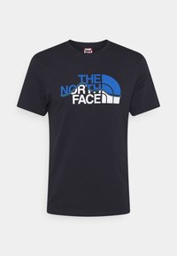 Camiseta de algodón negra con diseño del logo "The North Face" en azul y blanco, con texto curvado y gráfico de media cúpula en la parte frontal.