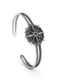 Silver-toned cuff bracelet featuring a compass design at the center, with a textured circular motif and two twisted wire bands.