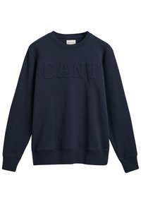 Sudadera de color azul marino hecha de suave tejido de algodón, con cuello redondo, mangas largas y un logotipo "GANT" en relieve en la parte delantera.