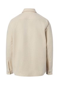 Jasnobeżowa koszula z długim rękawem, z prostym wzorem, tylną częścią na karczku i mankietami na guziki. Wykonana z teksturowanej tkaniny.
