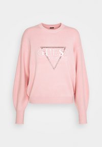Rosa Pullover mit langen, aufgebauschten Ärmeln. Vorne ein dreieckiges Design mit "GUESS" und "EST.1981" aus Strasssteinen. Weiche Textur.