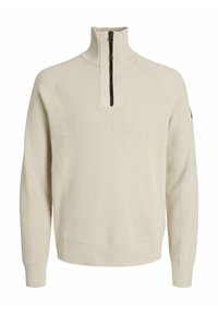 Beige gebreide pullover met een ritssluiting tot de helft van de kraag, ribbelstructuur en aansluitende manchetten. Bevat raglanmouwen en een minimalistisch ontwerp.