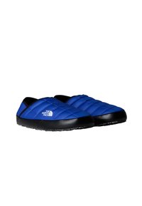 Scarpe slip-on blu, trapuntate e impermeabili con suola in gomma nera, caratterizzate dal logo The North Face sul lato e superiore in tessuto liscio.