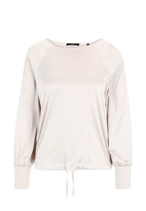 Svetlo béžový dlhý rukáv s okrúhlym výstrihom, raglánovými rukávmi, elastickými manžetami a nariaseným lemom s viazacím detailom. Hladká textúra.