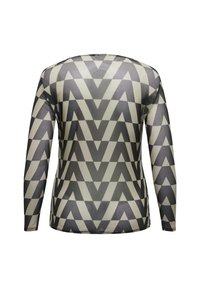 Top a maniche lunghe con un motivo zigzag geometrico in scala di grigi. Realizzato in tessuto leggero e liscio con una silhouette aderente.