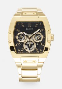 Montre rectangulaire dorée avec cadran noir, fonctionnalités chronographe et bracelet en métal poli. Comprend plusieurs sous-cadrans et de grands marqueurs d'heure.