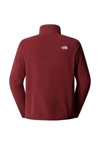 Pullover in pile di colore rosso scuro con colletto alto. Presenta un piccolo logo bianco sulla parte superiore del retro. Tessuto liscio, vestibilità standard, maniche lunghe.