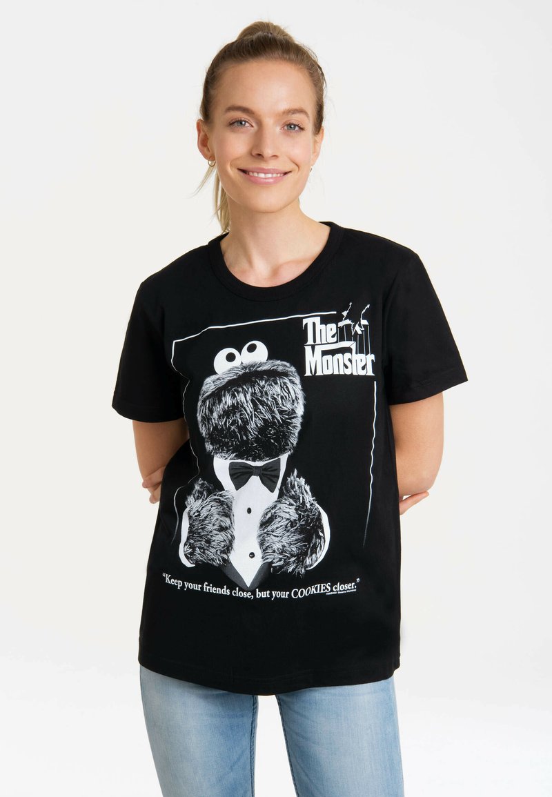 Black cotton t-shirt featuring a graphic of a furry monster in a tuxedo. Text reads, "Keep your friends close, but your COOKIES closer."
