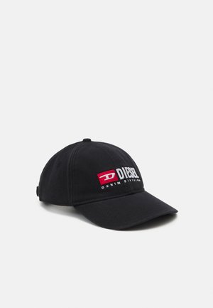 Black baseball cap made of cotton, featuring embroidered white and red "DIESEL" logo on the front. Curved visor and adjustable strap at the back.