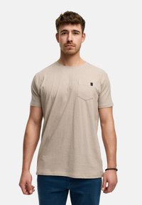 Beige Baumwoll-T-Shirt mit Rundhalsausschnitt und kurzen Ärmeln, ausgestattet mit einer kleinen Brusttasche und dezenten Nähdetails.