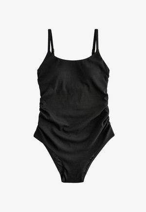 Juodas vientisas maudymosi kostiumėlis, pagamintas iš raukšlėtos medžiagos. Įrengtas plonais reguliuojamais petnešomis ir raukšlėmis priekyje, kad suteiktų papildomos tekstūros.