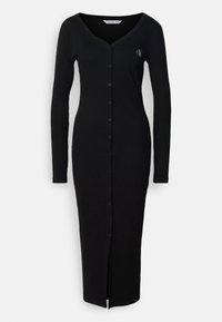 Musta, pitkähihainen neuletakkimekko, jossa on V-pääntie, napitus edessä ja korkealle reiteen ulottuva halkio. Valmistettu pehmeästä kankaasta, jossa on hienovarainen logoyksityiskohta.