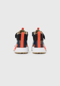 Pair of navy blue and orange hiking shoes with white textured soles and Gore-Tex tags, shown from the back on a white background.