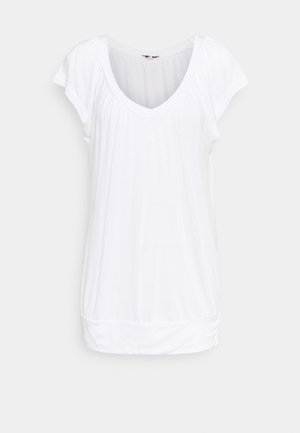 Top bianco a maniche corte con scollatura a V, dettagli arricciati sulle spalle e vestibilità slim. Tessuto morbido con orlo leggermente arricciato.