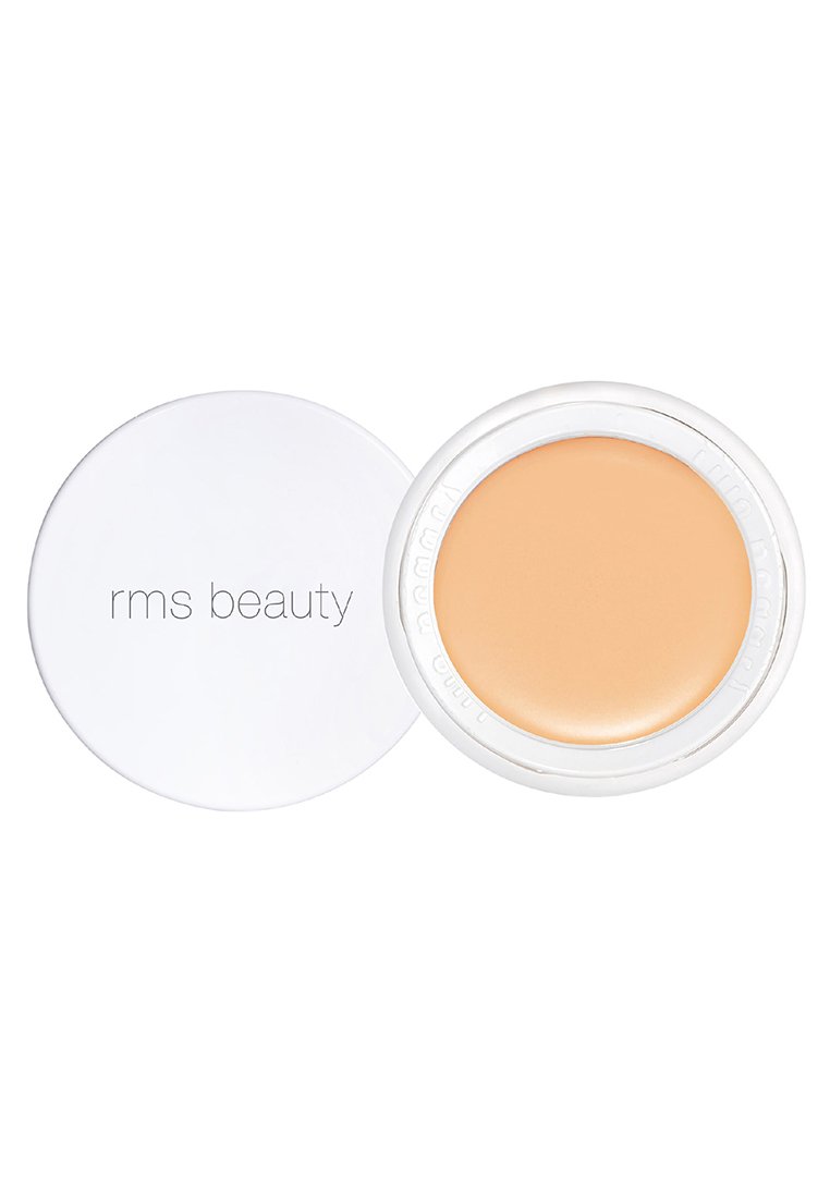 RMS Beauty concealer i en vit rund behållare. Krämig textur, ljus persikofärg, med en jämn yta och glansig finish.