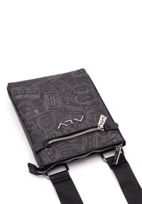 Borsa da viaggio nera con un motivo di francobolli, chiusura a zip e spallacci regolabili. Realizzata in materiale resistente con dettagli in metallo argentato.