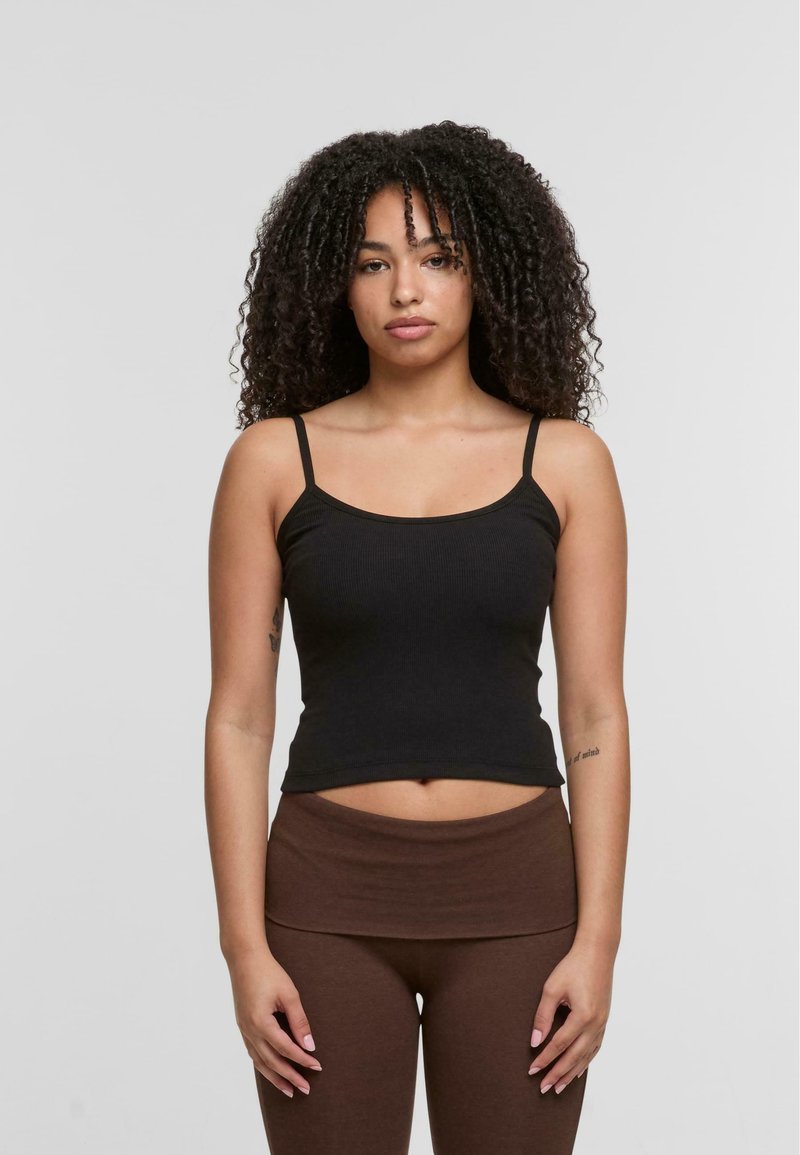 Black ribbed tank top with thin straps, fitted design, and rounded neckline, paired with brown high-waisted leggings. Smooth texture.