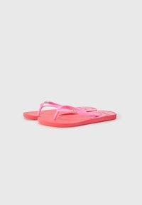 Rosa flip-flops med gjennomsiktige stropper, teksturerte gummisåler og logo-detalj. Designet har en ensfarget smak og minimalistisk stil.