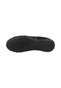 Black sneaker with a textured upper, patterned mesh design, and a rubber sole featuring raised circular grip nodes. Complicated detailing near the heel.
