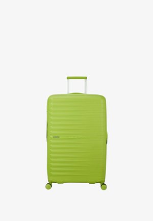 Green hardshell suitcase with a textured design, dual spinner wheels, and a retractable handle, featuring a smooth finish and zip closure.